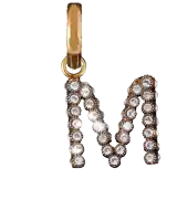 a gold letter m pendant with diamonds on it