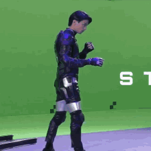 a close up of a person 's arm with a green screen in the background