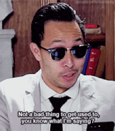 a man wearing sunglasses and a white suit says not a bad thing to get used to you know what i 'm saying