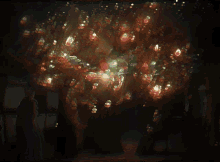 a painting of a tree with a lot of lights hanging from it
