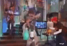 a blurry picture of people in a room with the url rbd.gif