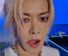 a close up of a person making a funny face with their tongue sticking out .