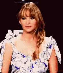 a woman in a blue and white dress is making a funny face