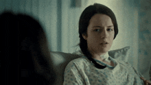 a woman in a hospital gown with a tube in her neck