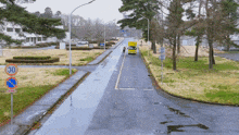 a yellow truck is driving down a street with a sign that says 30 on it