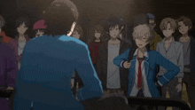 a group of people are standing around a man in a blue jacket