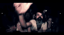 a crowd of people at a concert with one man taking a picture of himself