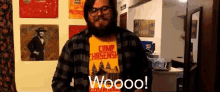 a man with a beard wearing a yellow shirt that says camp chasers