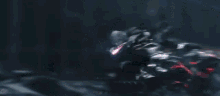 a person is riding a motorcycle down a street in a video game with purple lights .