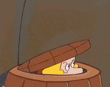 a cartoon character wearing a hat is sticking his head out of a wooden barrel .