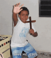 a young boy holding a wooden cross with the words save me jesus on the bottom