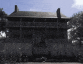 a large house with a fence in front of it that says ' ghostlife.com ' on the bottom