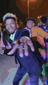a man in a suit is dancing with another man