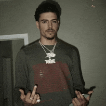 a man wearing a shirt that says ' xtreme ' on it is giving the middle finger