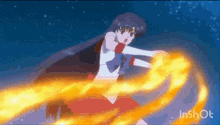 a girl in a red dress is holding a fireball in her hand .