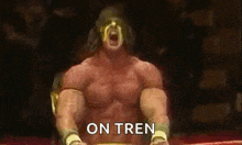 a wrestler is sitting in a ring with his mouth open and the words `` on tren '' written above him .