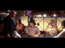 a man in a cowboy hat is talking to another man