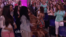 a group of women are dancing in front of a crowd and the word ellen is on the bottom of the screen