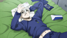 a person laying on a bed with a blue scarf that says blue