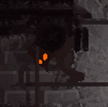 a pixel art drawing of a dark room with a red light coming out of the corner .