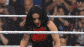 a woman is in a wrestling ring with a sign that says live kansas city on it