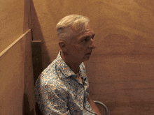 a man in a blue shirt with circles on it