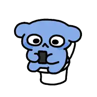 a blue cartoon character is sitting on a toilet with a cell phone in his mouth .