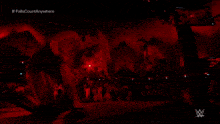 a man in a dark room with a w logo on the bottom right corner