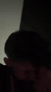 a man and a woman are posing for a photo in the dark