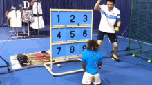 a man stands in front of a board with numbers on it