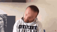 a man wearing a parental advisory sweatshirt is making a face .