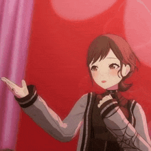 a girl is standing in front of a red curtain and holding her hand out .