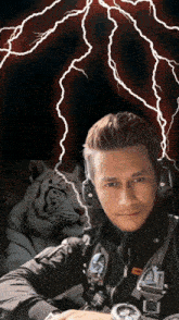 a man wearing headphones and a watch stands in front of a tiger