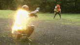 a man in a superhero costume is kneeling down in a field with a glowing light behind him