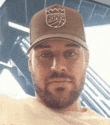 a man with a beard is wearing a kings hat