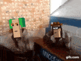a gif of two cartoon characters standing next to a unicef sign