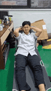a man in a white shirt and black pants is laying on a bed