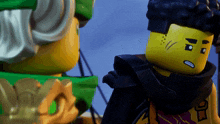 two lego figures are standing next to each other and one of them has a tattoo on his face