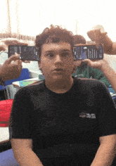 a young man wearing a black shirt that says col est sao paulo