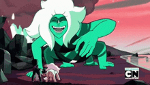 a cartoon character is laughing while standing next to a giant green monster .