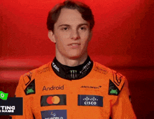 a man wearing an orange shirt that says android