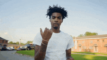 a man in a white t-shirt giving the middle finger