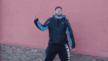 a man wearing a black and blue hoodie with the word twenty on the side