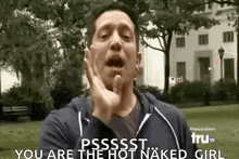 a man is making a funny face while standing in a park and says `` you are the hot naked girl '' .