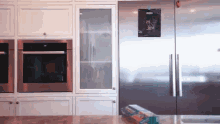 a kitchen with a stainless steel refrigerator and a stainless steel oven