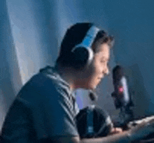 a man wearing headphones and a microphone is playing a video game .