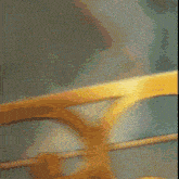 a blurry picture of a yellow railing with a green background .