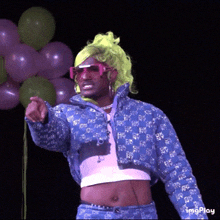 a man in a wig and sunglasses is pointing at something with balloons in the background