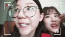 two girls are making funny faces in front of a recorder that says rec on it