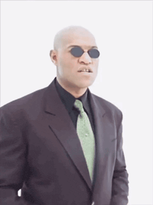 a man in a suit and tie is wearing sunglasses .